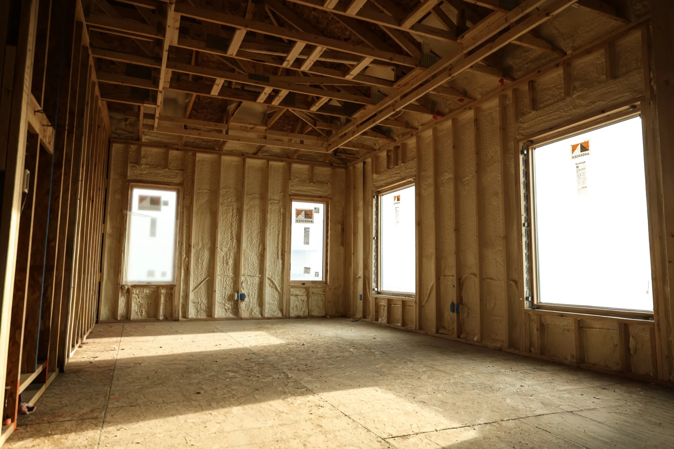 Professional installer applying spray foam insulation in an Arizona building